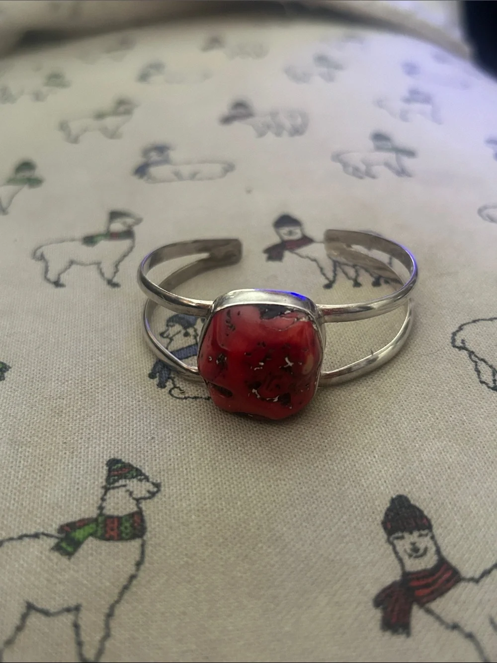 Silver bracelet with rough coral stone.